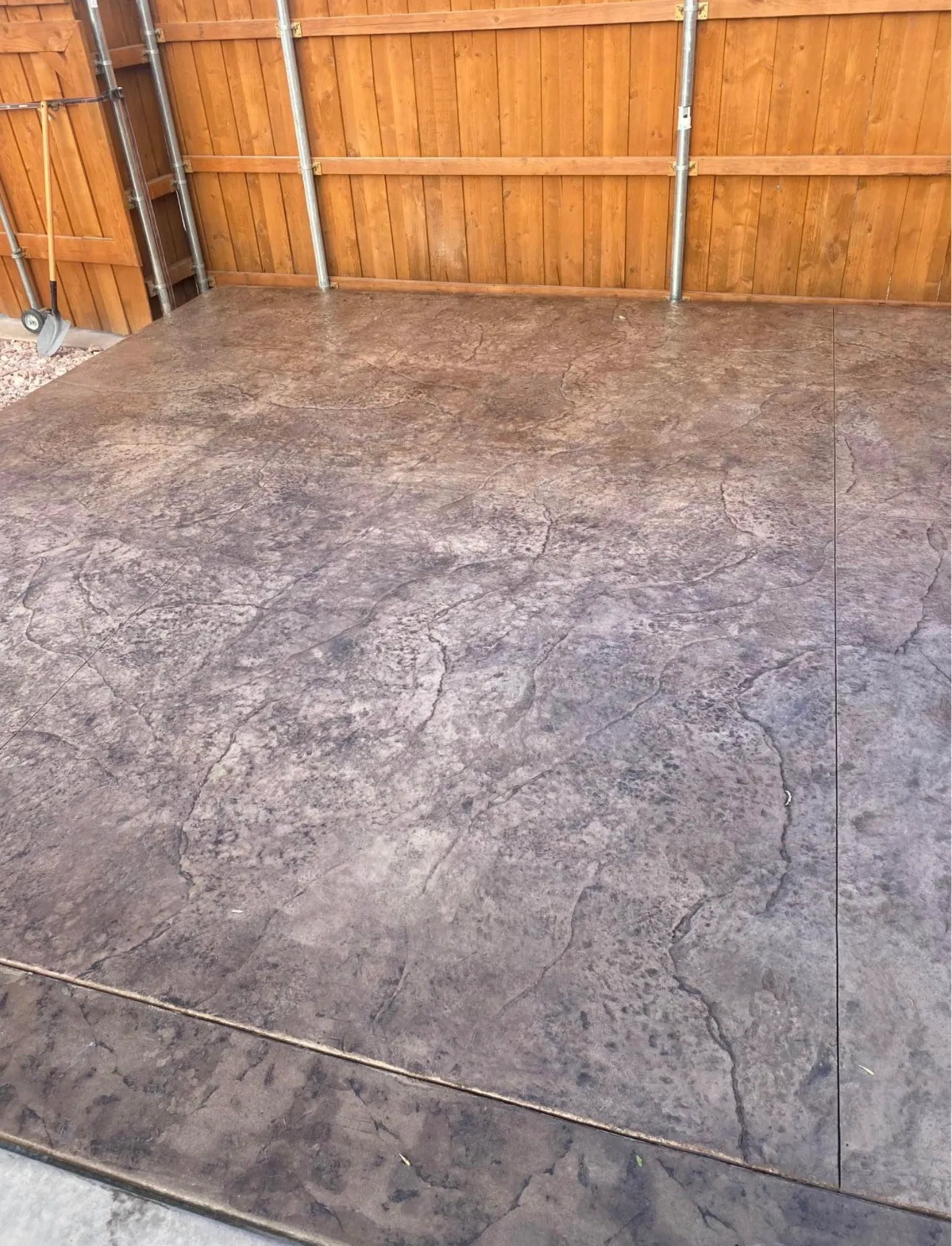 Stamped concrete patio in a warm red brown finish