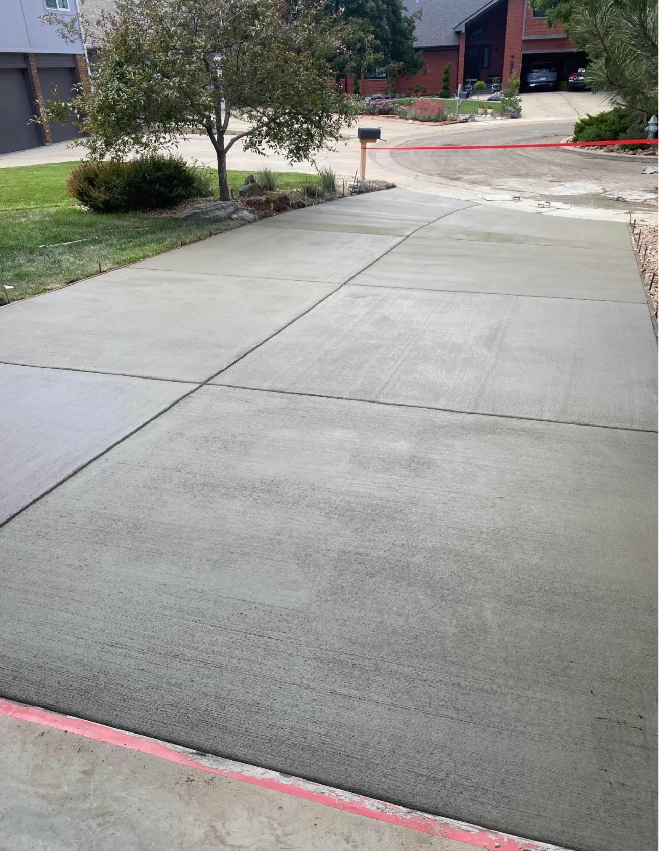 Wide concrete patio finished under a covered porch
