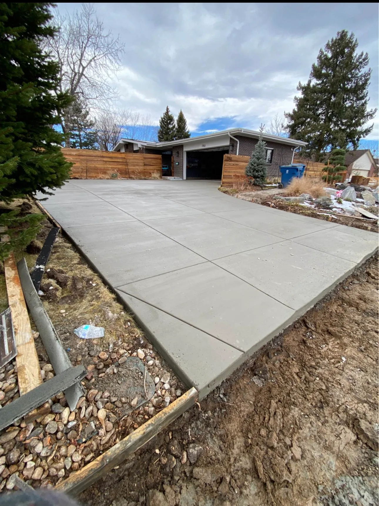Wide concrete walkway running up to a garage door