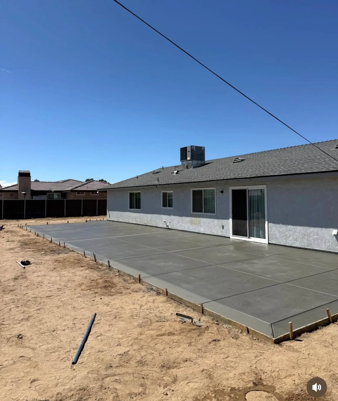 Large concrete driveway slab finished at a single storey ranch house
