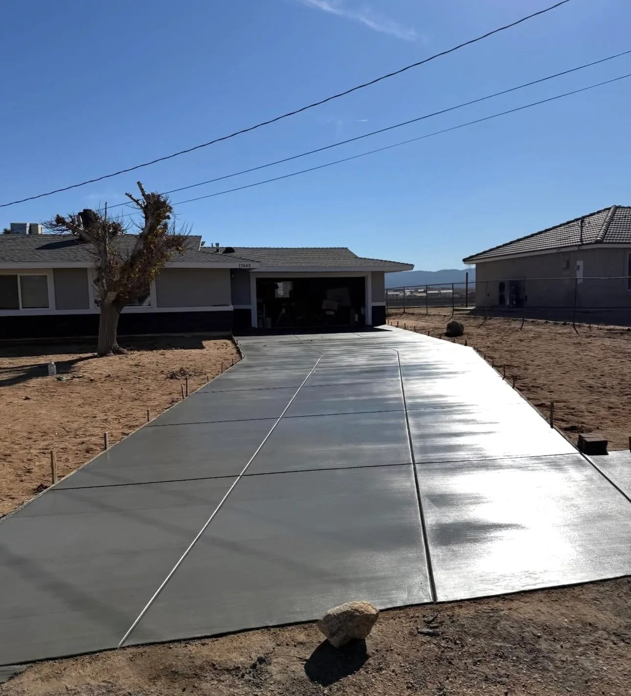 Freshly finished concrete driveway slab with a smooth broom finish