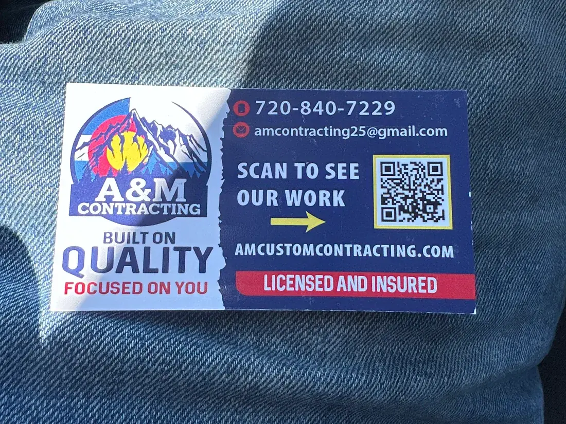 A&M Contracting yard sign showing the company phone number and website
