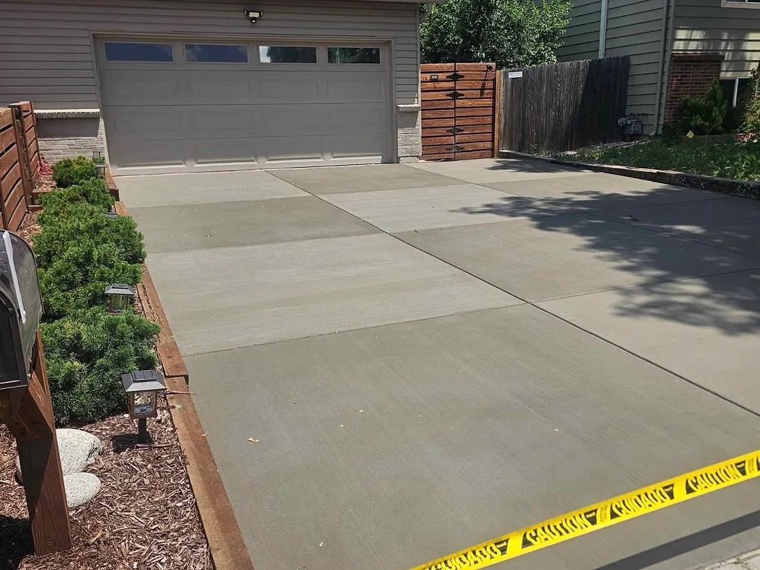Freshly poured concrete driveway taped off while it cures