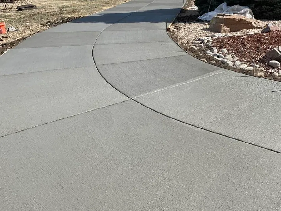 Sweeping curved concrete driveway with a smooth broom finish