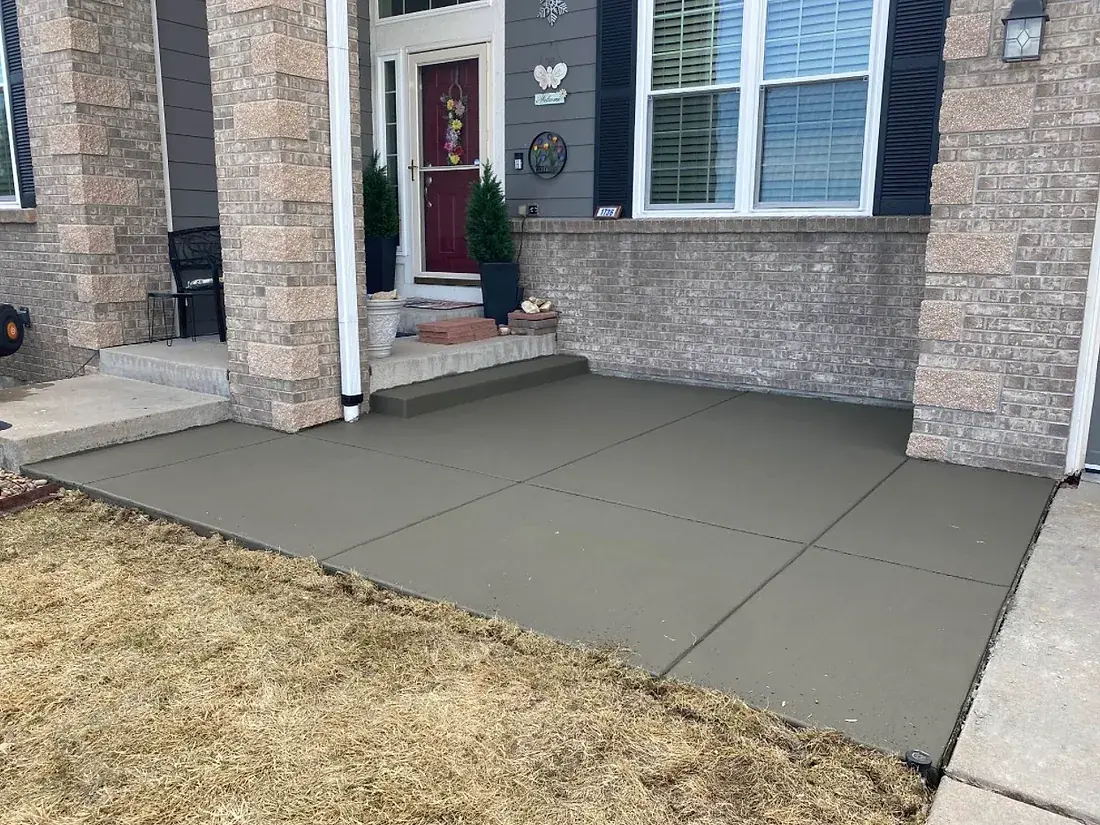 Concrete porch, steps and walkway poured at the front of a brick home