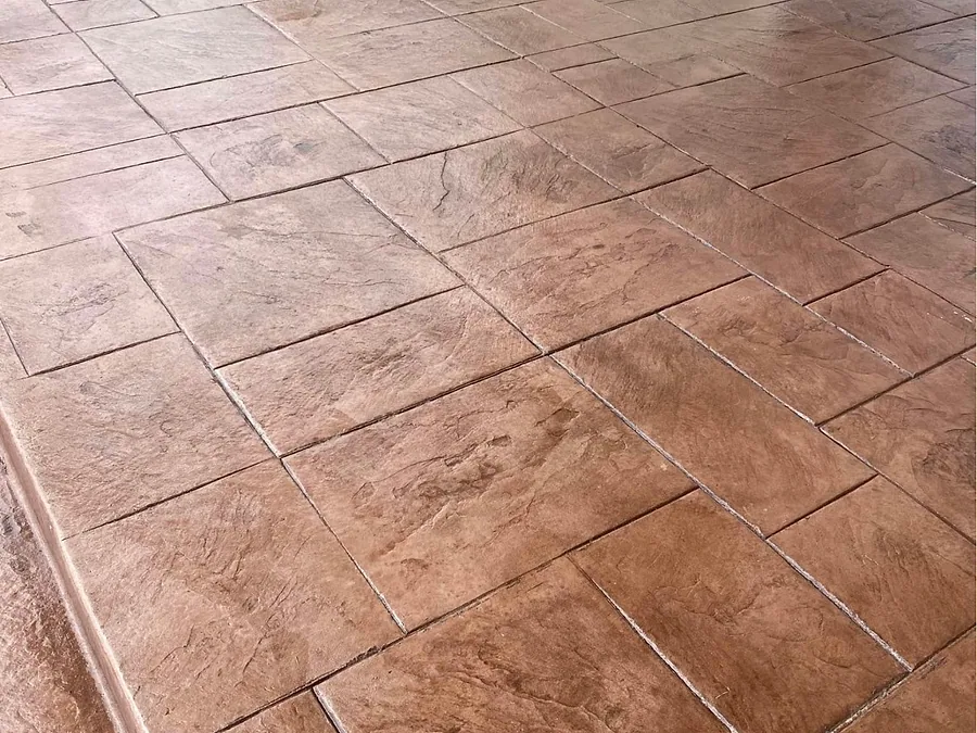 Large stamped concrete patio in a warm red brown ashlar slate pattern
